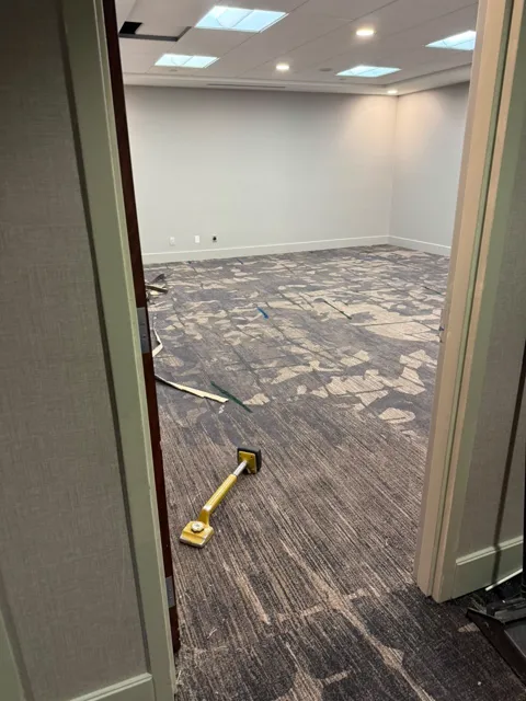 Patterned commercial carpet being fitted in an office meeting room